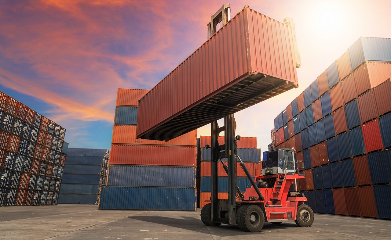 Forklift lifting a container